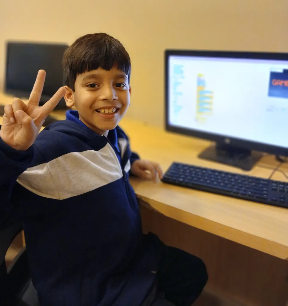 Student celebrating Scratch game creation